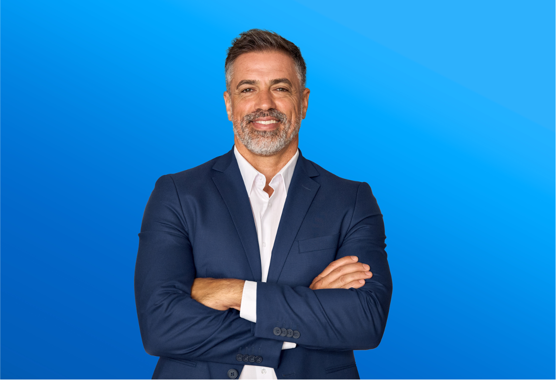 Man in professional clothing smiling over isolated blue background